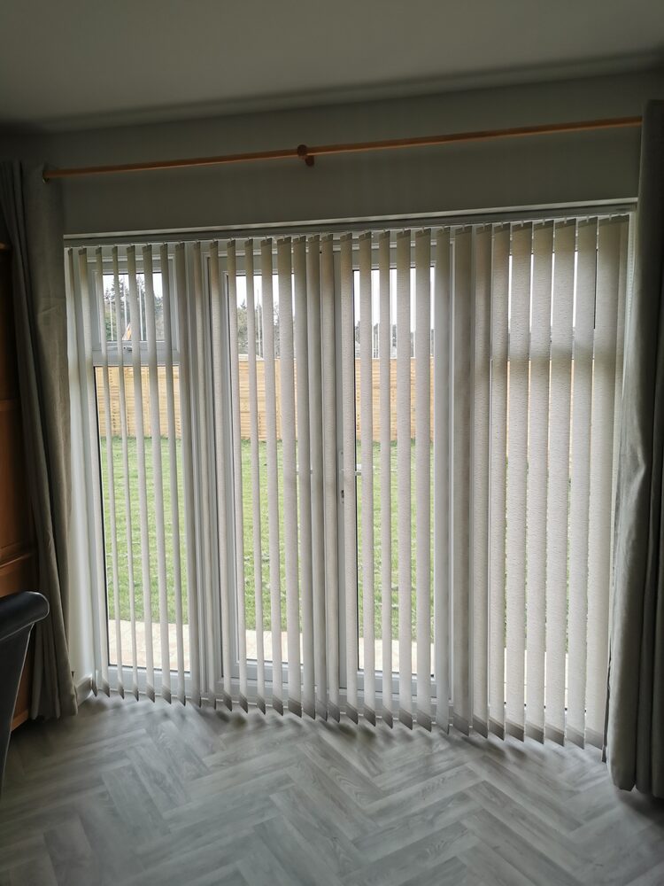 White vertical blinds with chainless weights fitted to french doors